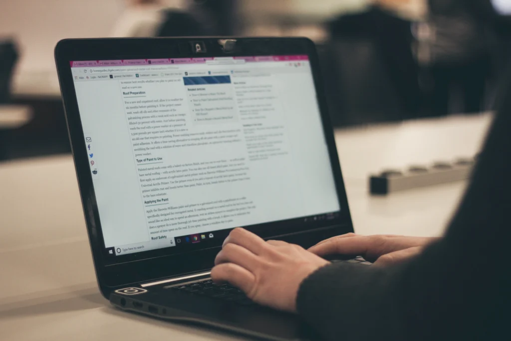 person typing with hands on a laptop