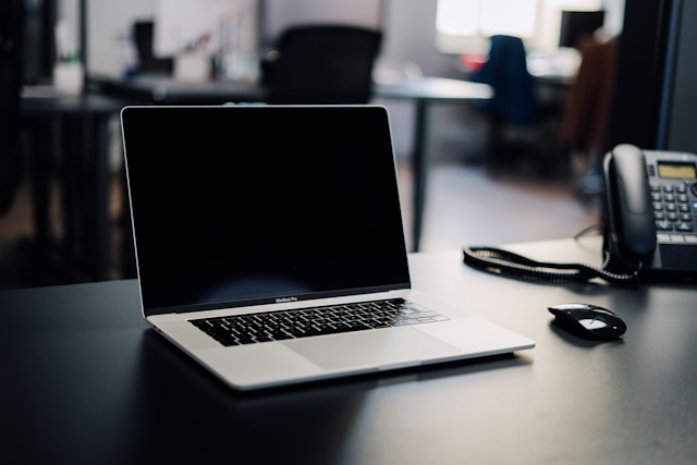laptop-landline-phone-placed-on-a-desktop