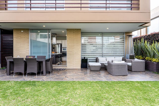 Outdoor-patio-with-sofa-chairs-and-lawn