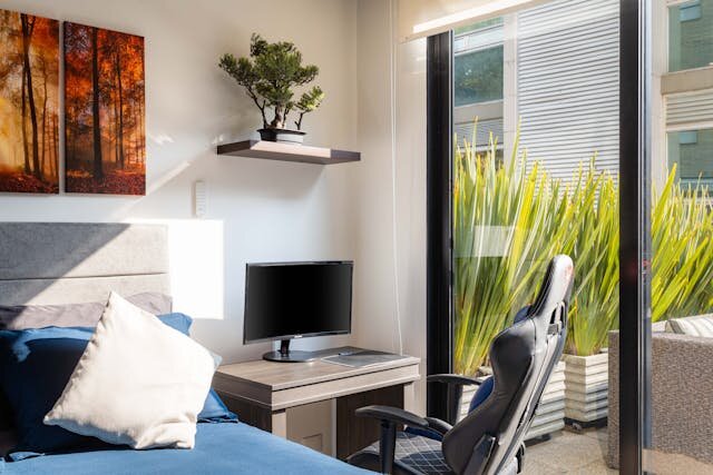 bedroom-with-work-table-chair-wall-art-with-glass-sliding-windows
