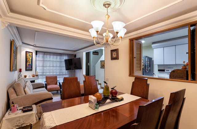 Living-room-with-sofa-dining-table-and-serving-window